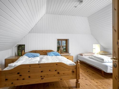 a bedroom with two beds in a white room at Holiday Home Agrippa - 30m to the fjord by Interhome in Løgstør