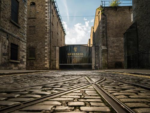an empty street in an alley with a gate at Maldron Hotel Kevin Street, Dublin City in Dublin
