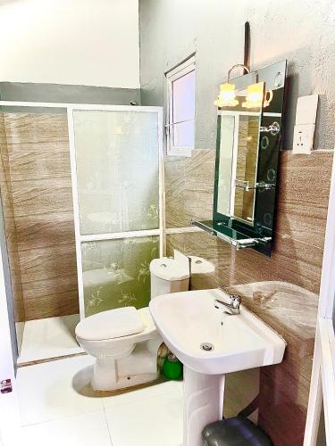a bathroom with a toilet and a sink at Holiday Inn Unawatuna in Unawatuna