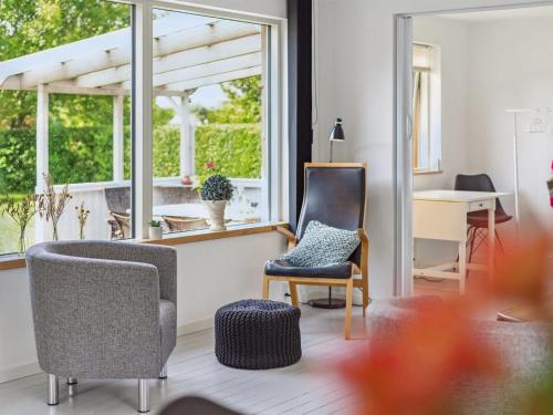 a living room with two chairs and a window at Holiday Home Henric - 500m from the sea by Interhome in Strøby