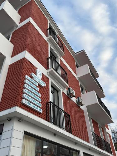 a red brick building with a sign on it at Stylish House in Kutaisi