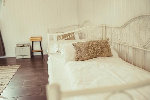 a white bed with a pillow on it in a room at Stodoła Rasztów 