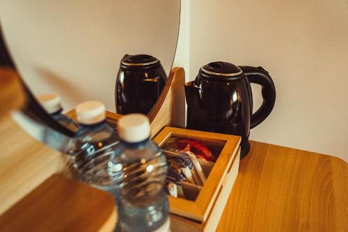 two bottles of water sitting on a wooden table at Stodoła Rasztów 