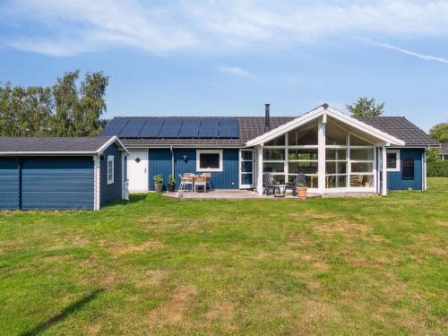 a blue house with a large yard at Holiday Home Asvalde - 200m to the inlet by Interhome in Vordingborg