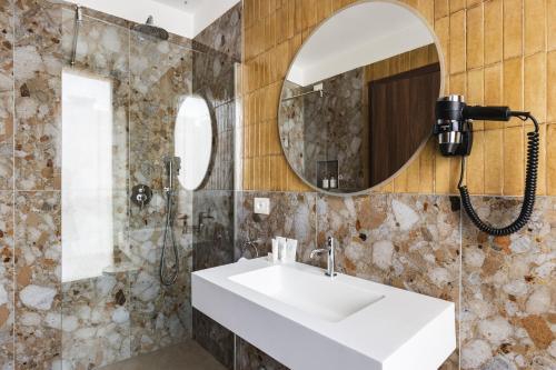 a bathroom with a sink and a mirror at Casa D'Este - Hotel Ferrara in Ferrara