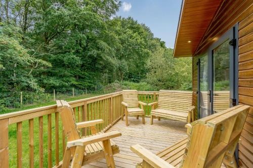 a wooden deck with benches on a house at Clumber Park Lodges in Worksop