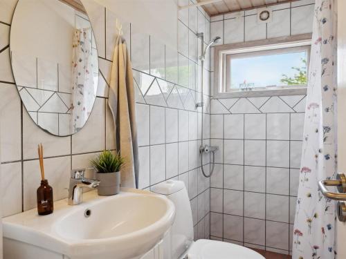 a bathroom with a sink and a toilet at Holiday Home Felicity - 250m from the sea by Interhome in Karrebæksminde