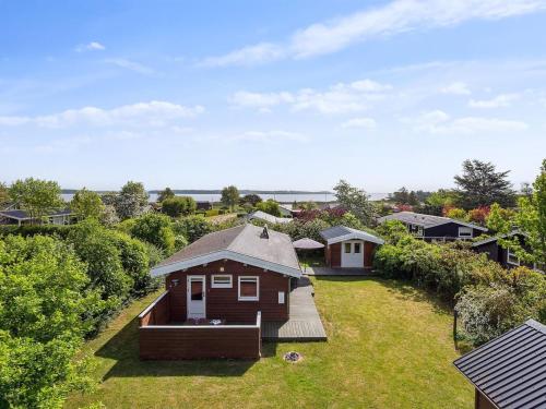 a small house sitting on top of a lush green yard at Holiday Home Felicity - 250m from the sea by Interhome in Karrebæksminde