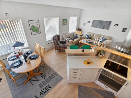 a kitchen and a living room with a table and chairs at Apartment Dagne - 400m from the sea by Interhome in Hasle