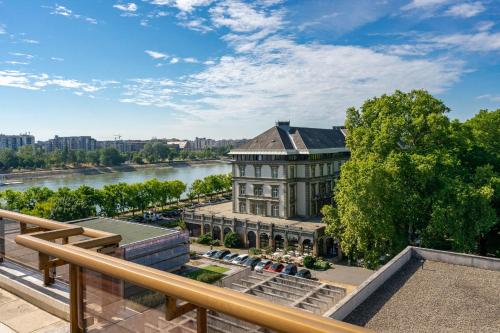 a view of a building with a river in the background at Ensana Grand Margaret Island in Budapest