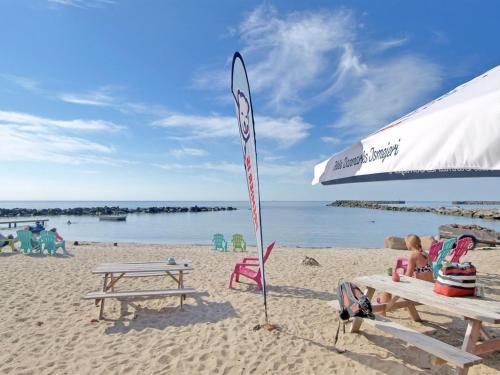a surfboard stuck in the sand on a beach at Apartment Dagne - 400m from the sea by Interhome in Hasle