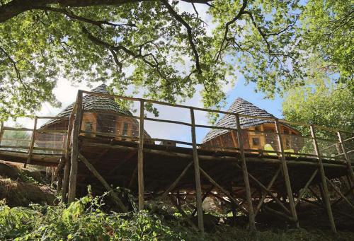 a wooden bridge with a building on top of it at Terragora Lodges - Hébergement atypique in Les Épesses