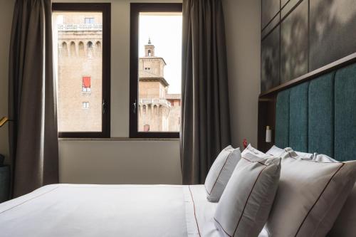 a hotel room with a bed and a window at Casa D'Este - Hotel Ferrara in Ferrara