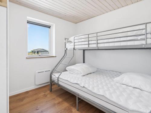a bedroom with a bunk bed and a window at Holiday Home Ika - 450m from the sea by Interhome in Nordborg