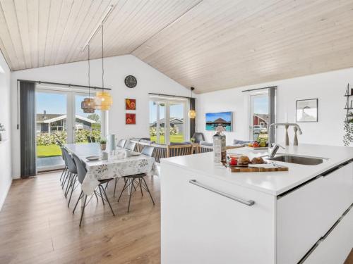 a kitchen and dining room with a table and chairs at Holiday Home Ika - 450m from the sea by Interhome in Nordborg