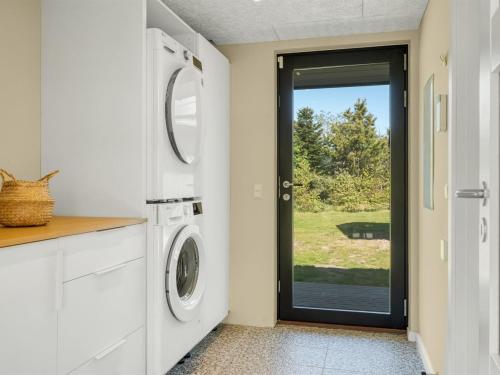 a white laundry room with a washer and dryer at Holiday Home Alfrede - from the sea by Interhome in Hals