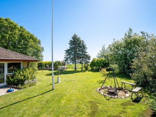 a yard with a picnic table and a swing at Holiday Home Maleen - 150m to the inlet by Interhome in Nakskov