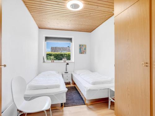 a hospital room with two beds and a window at Holiday Home Maleen - 150m to the inlet by Interhome in Nakskov