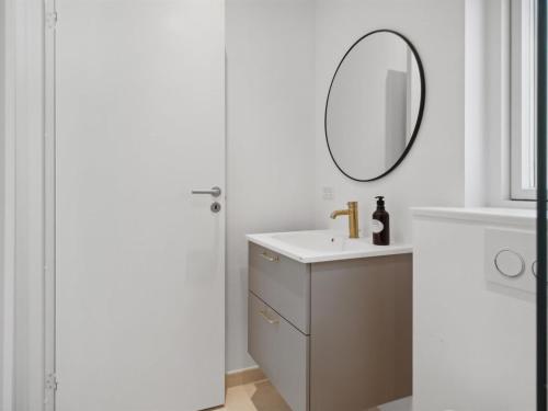a bathroom with a sink and a mirror at Holiday Home Tinja - 900m from the sea by Interhome in Højby