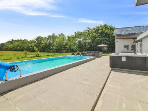a swimming pool in the backyard of a house at Holiday Home Melin - 7km from the sea by Interhome in Højer