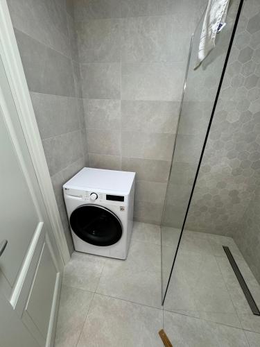 a bathroom with a toilet and a glass shower at Luxury Studios at Unique opposite Palas with Parking in Iaşi