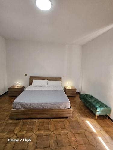 a bedroom with a bed and two night stands with lamps at CASA MIA GUESTHOUSE AFFITTA CAMERE Foresteria 