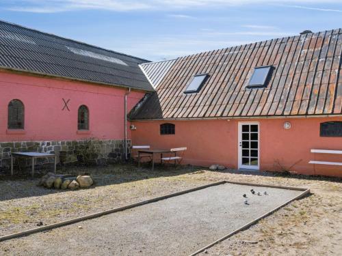 two buildings with a ping pong table in a courtyard at Holiday Home Elisabetha - 16km from the sea by Interhome in Randbøl