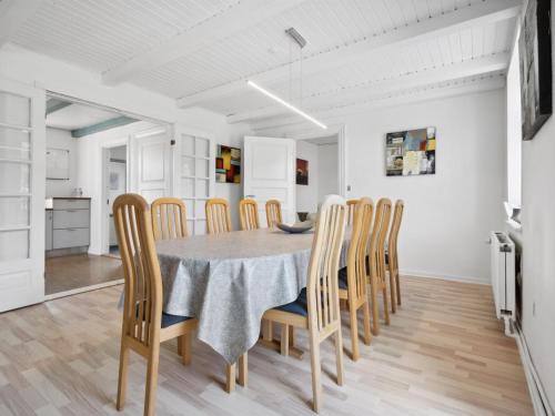 a kitchen and dining room with a table and chairs at Holiday Home Essie - 20km from the sea by Interhome in Agerskov