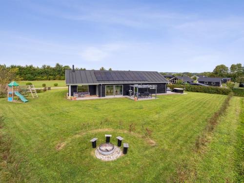 an aerial view of a house with a playground at Holiday Home Amdi - 700m from the sea by Interhome in Neder Lysabild