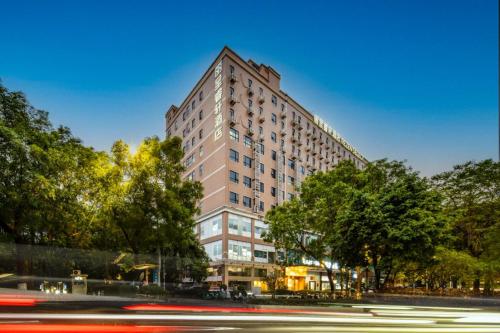 a tall building with a street in front of it at Rezen Select Hotel (Guangzhou Keyun Road Financial City) in Guangzhou