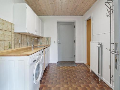 a kitchen with a washer and dryer at Holiday Home Ingward - 750m from the sea by Interhome in Vestervig