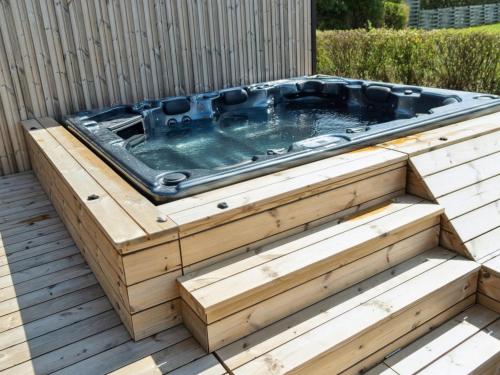 a hot tub in a wooden box on a deck at Holiday Home Ottmar - 150m from the sea by Interhome in Bagenkop