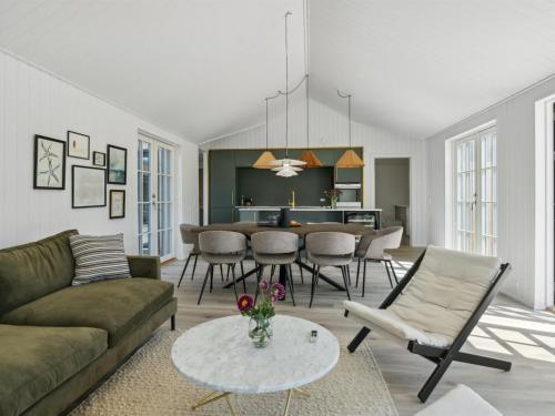 a living room with a couch and a table at Holiday Home Ottmar - 150m from the sea by Interhome in Bagenkop