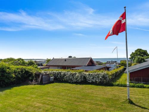 a red flag on a pole in a yard at Holiday Home Thrugils - 200m from the sea by Interhome in Haderslev