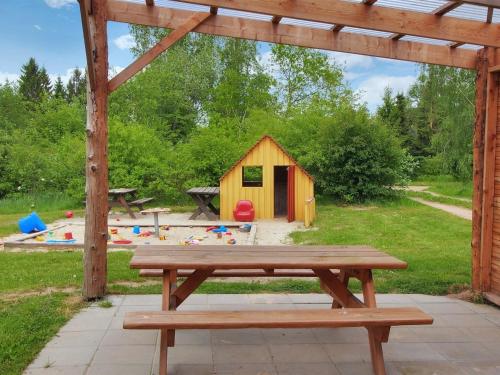 a picnic table in a park with a play house at Holiday Home Herta by Interhome in Fårvang