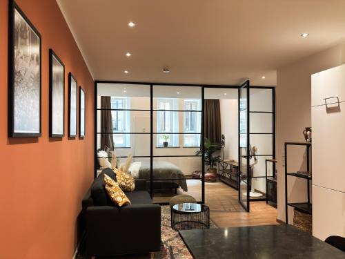 a living room with a couch and a bed at Brunnen Apartments in Nürnberg