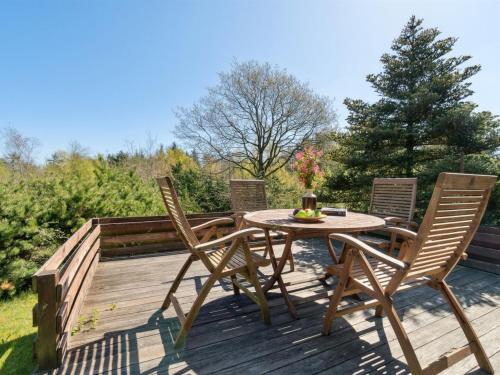 a patio with a table and chairs on a deck at Holiday Home Ewy - 150m to the fjord by Interhome in Fur