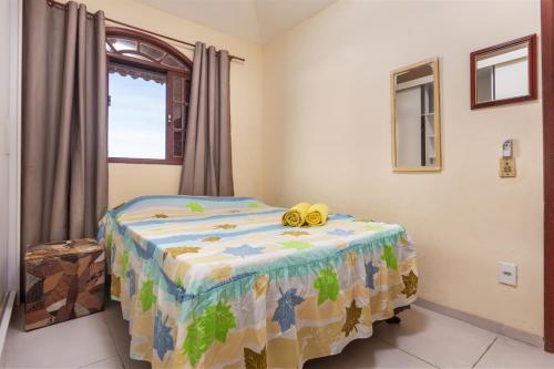 a bedroom with a bed with a yellow toy on it at Casa Vista para Montanhas em Búzios Próxima a Praias e Comércio in Búzios