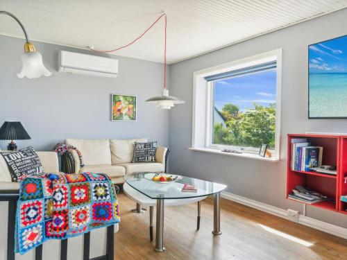 a living room with a couch and a table at Holiday Home Swaantje - 150m to the fjord by Interhome in Fur