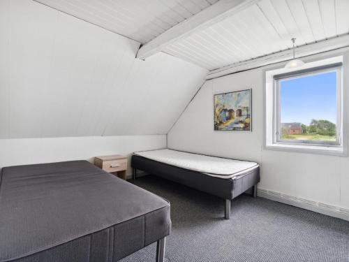 a bedroom with a bed and a window at Holiday Home Swaantje - 150m to the fjord by Interhome in Fur