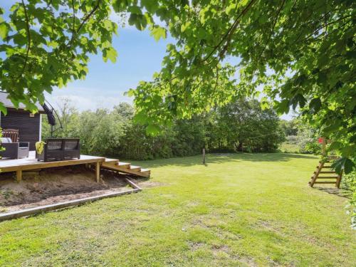 a picnic table in the yard of a house at Holiday Home Bjerne - 250m to the inlet by Interhome in Roslev