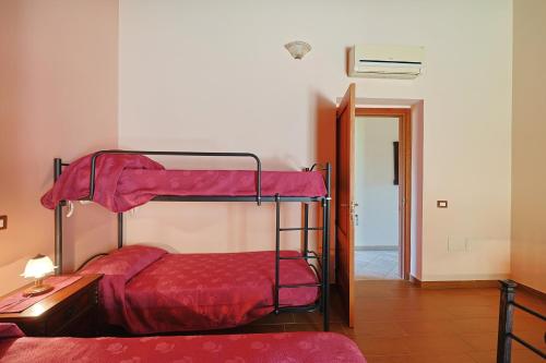 a bedroom with two bunk beds in a room at Bed And Breakfast Sciarammola in Patti