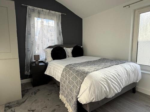 a bedroom with a bed and a window at The Clare Court 6BR Luxury Retreat - Sleeps 14 with Complimentary Access to Billing Aquadrome Holiday Village for Swimming - 2 nights minimum in Kingsthorpe