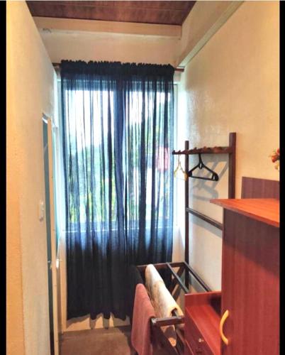 a room with a window with a black curtain at Holiday Inn Unawatuna in Unawatuna