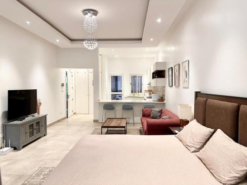 a bedroom with a bed and a living room at Cozy, fully equipped apartment in Mermoz, Dakar in Dakar