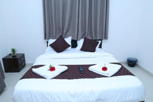 two beds in a room with two towels with strawberries on them at Hide away stay in Pune