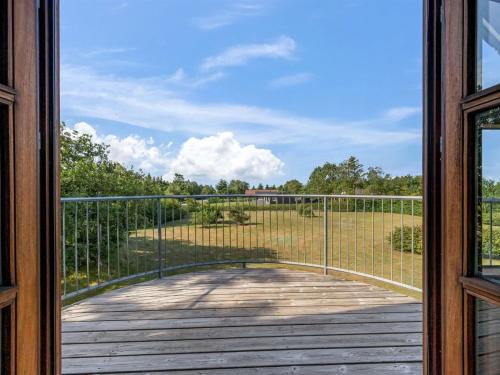 a door to a porch with a view of a field at Holiday Home Hendrina - 250m to the fjord by Interhome in Skjern