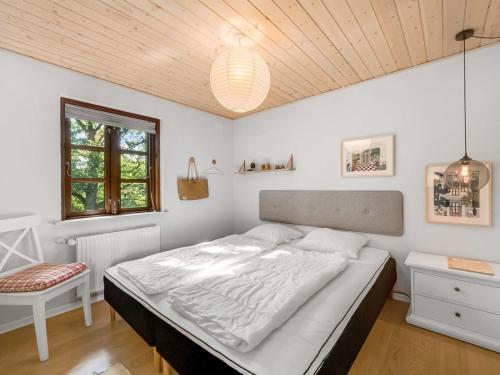a bedroom with a large bed and a window at Holiday Home Hendrina - 250m to the fjord by Interhome in Skjern