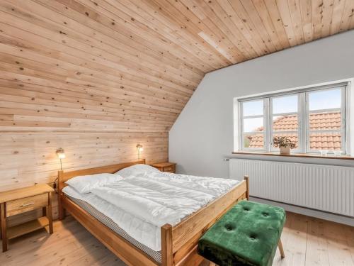 a bedroom with wooden walls and a bed in a room at Holiday Home Soria - 600m to the fjord by Interhome in Vemb