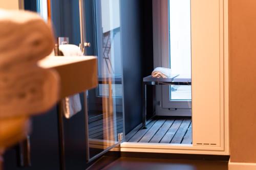 a bathroom with a mirror next to a sink at Casa D'Este - Hotel Ferrara in Ferrara
